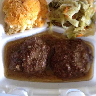 Hamburger steak with mac n cheese and cabbage.