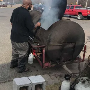a man cooking a large pig