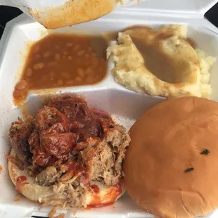 pulled pork sandwich, mashed potatoes, and gravy