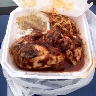 Half a chicken with spaghetti and rice and gravy