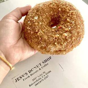 a hand holding a doughnut