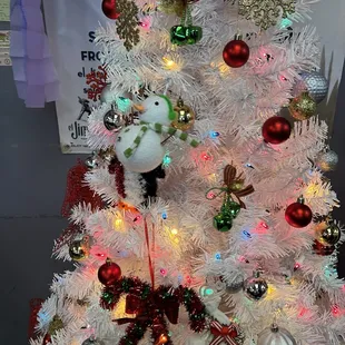 a white christmas tree with ornaments