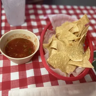 a bowl of chips and a bowl of salsa