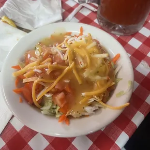 a plate of food on a red and white checkered tablecloth