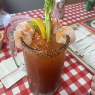 a bloody drink with shrimp and celery