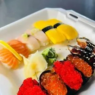 a tray of sushi and rolls