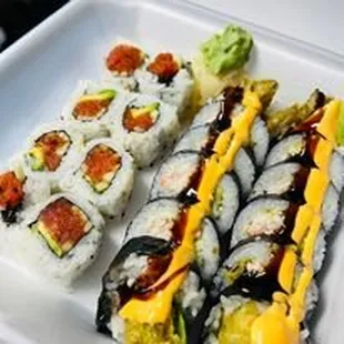 a plate of sushi and rolls