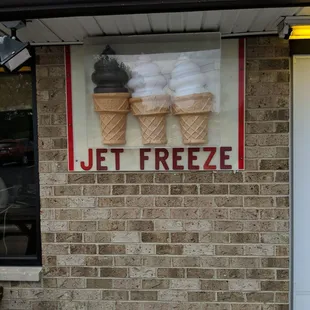 two ice cream cones on a brick wall