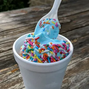 a cup of ice cream with sprinkles