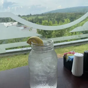a glass of water with a lemon wedge in it