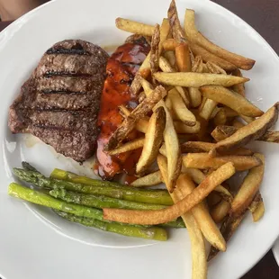 A well done steak (was supposed to be medium) , bbq chicken, asparagus and fries.