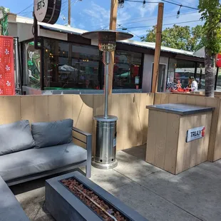 Outdoor patio next to the sidewalk.