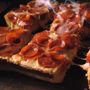 a close up of a pepperoni pizza