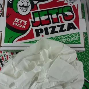 a box of jets pizza on a table