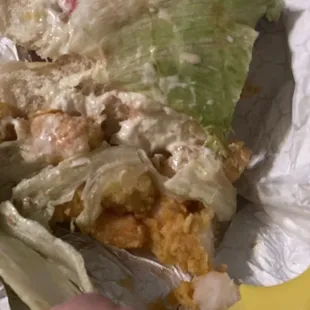 a sandwich with lettuce and tomatoes