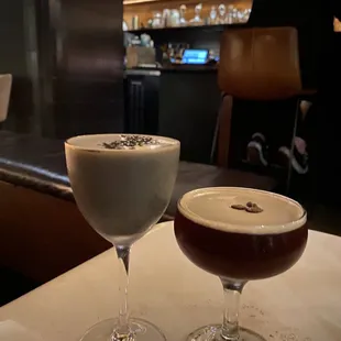 two glasses of coffee on a table