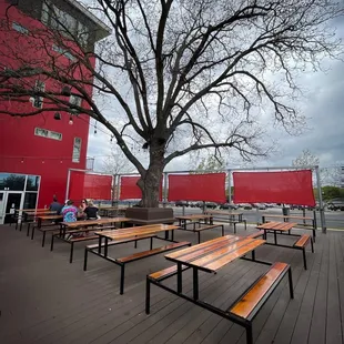 Nice outdoor deck with tree.