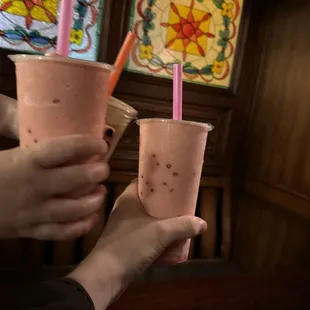 Strawberry Bubble Tea with strawberry popping boba in one of their booths