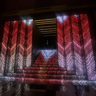 a stage with red, white, and blue lights