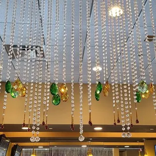 chandelier of wine bottles suspended from the ceiling