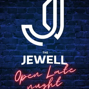 a neon sign on a brick wall