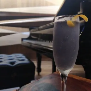 a glass of wine and a piano