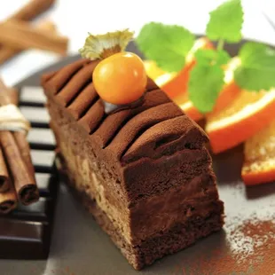 a piece of chocolate cake with orange slices