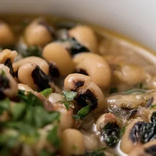 a bowl of black eyed peas and spinach