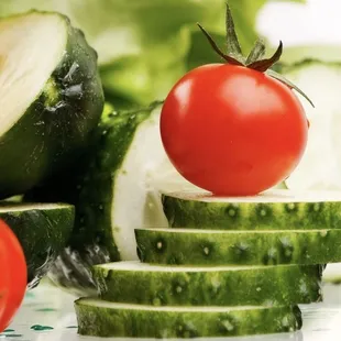 a pile of sliced cucumbers and tomatoes