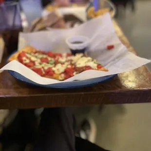a slice of pizza on a tray