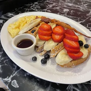 Excellent meal. Belgian waffle with fruit, bacon, and cheese eggs. The waffle was made with cinnamon. Very good.