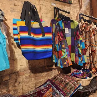 a variety of clothing hanging on a wall