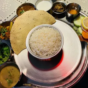 a bowl of rice with a side of vegetables