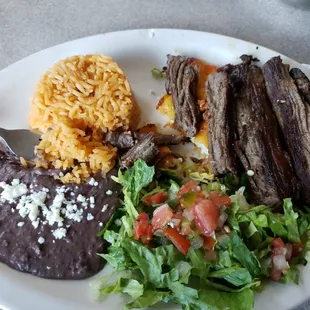 Tampiqueina platter...cheese enchiladas with fajits on top.