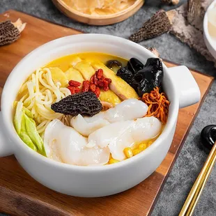 a bowl of food with chopsticks