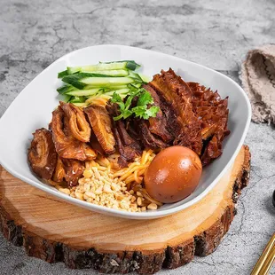 a bowl of food with chopsticks