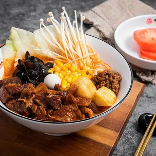 a bowl of food on a cutting board