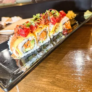 a sushi roll on a black plate