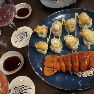 a plate of sushi and a glass of wine