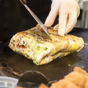 a person preparing food on a grill