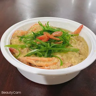 a bowl of soup with shrimp and vegetables