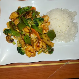 a plate of stir fried vegetables and rice