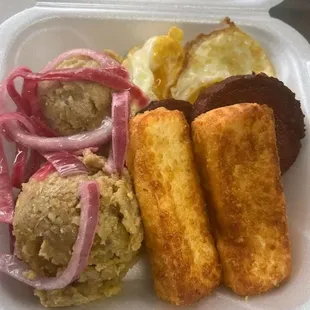 Mangú con Los Tres Golpes: Buttered mashed plantain, topped with pickled onion, served with fried cheese, fried salami, fried eggs