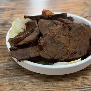 a bowl of food on a wooden table