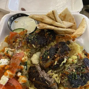 Kofta plate with rice salad and pita.