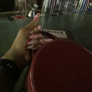 a woman's hand holding a cigarette