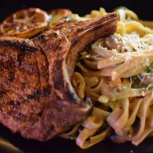 Grilled Pork Chop over spinach fettucini