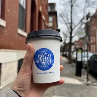 a hand holding a cup of coffee