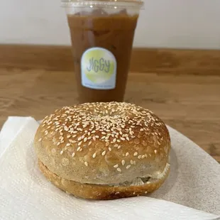 Sesame bagel w/ cream cheese and a winter orange iced coffee -----