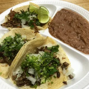 Two carnitas, one beef taco.. Side of beans Perfecto!!!!!